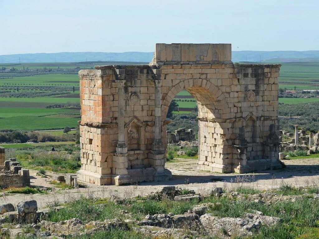 The Triumphal Arch at Volubilis — a striking Roman monument set against Morocco’s fertile plains, reflecting centuries of imperial history and cultural exchange.