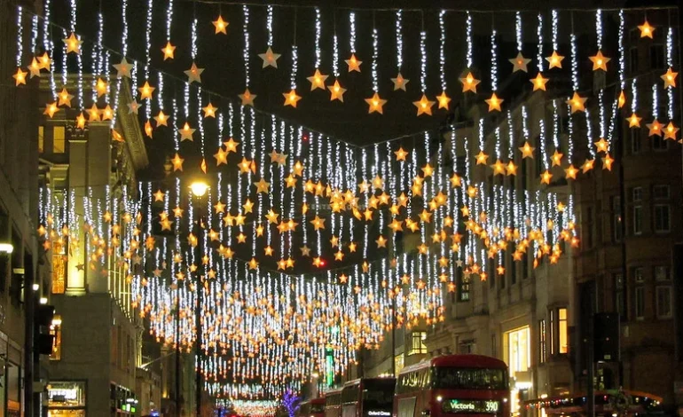 Oxford Street Christmas lights 2025 glowing star display above London buses at night