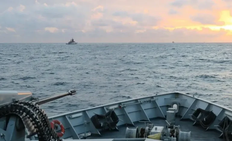Royal Navy vessel tracking ships on the horizon during a Channel patrol at sunrise