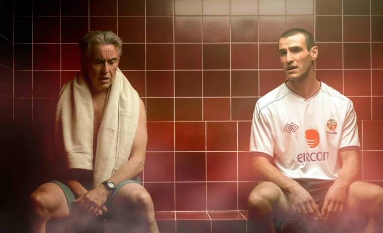 Saipan review image of Steve Coogan and Éanna Hardwicke portraying Mick McCarthy and Roy Keane in a tense steam room scene from the film