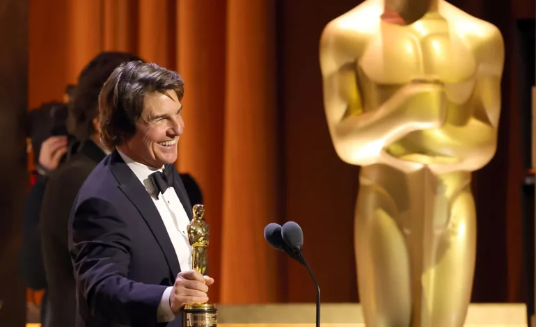 Tom Cruise holding his trophy on stage after receiving the honorary Oscar at the Governors Awards during the Tom Cruise honorary Oscar presentation