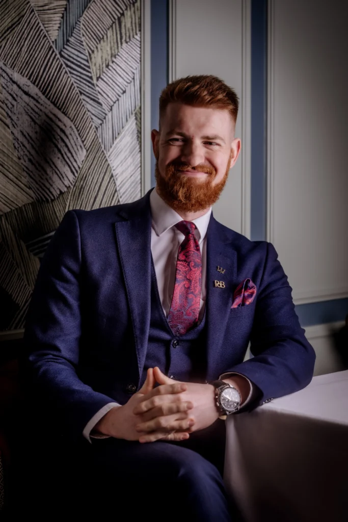 Front of house host, Charlie, seated inside Tom Brown at The Capital.