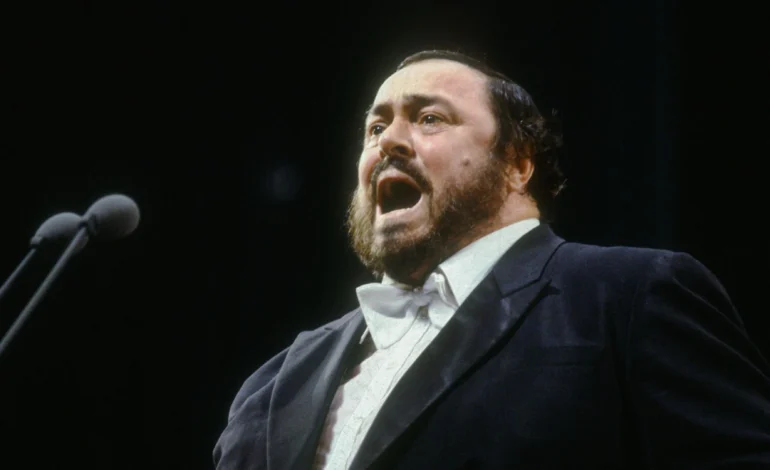 Luciano Pavarotti performing on stage, referenced in the Pavarotti statue controversy following the ice rink installation in Pesaro.