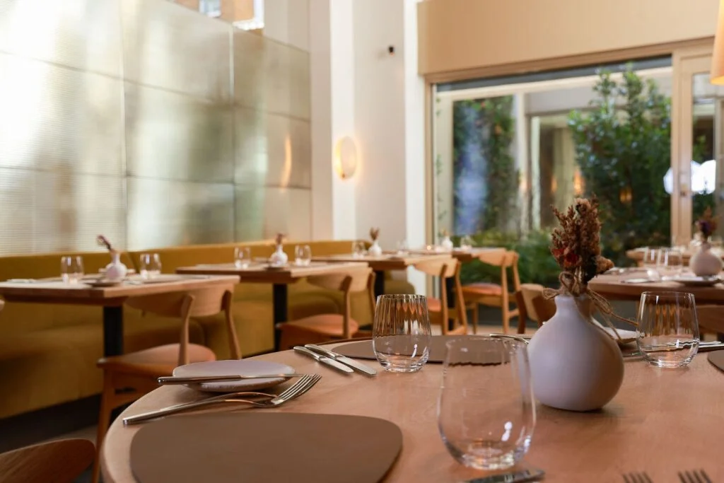 The dining room at 74 Charlotte Street, with softly lit booths and a calm, contemporary atmosphere in the heart of Fitzrovia.