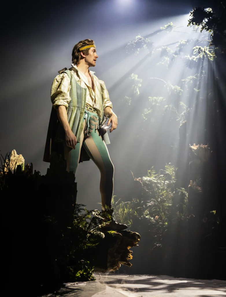 A moment of stillness in Into the Woods at the Bridge Theatre, where shafts of light and a richly imagined forest underscore the production’s blend of fairytale wonder and moral reckoning