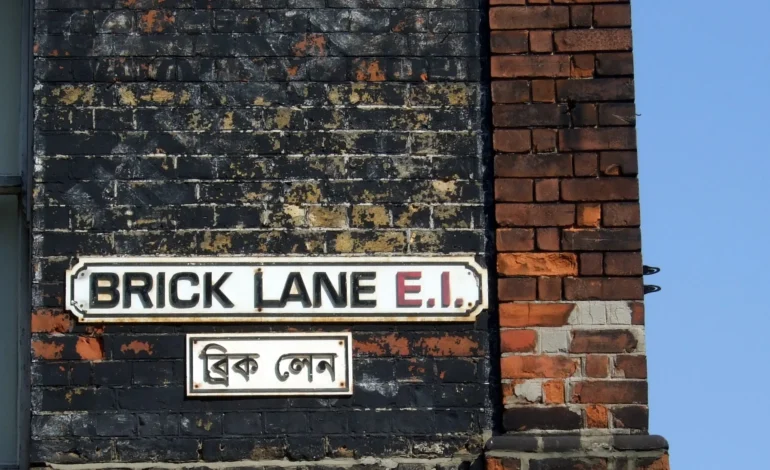 Brick Lane street sign in east London highlighting the effects of London gentrification on historic neighbourhoods