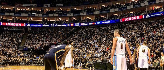 NBA returns to London as players stand on court in front of a packed crowd during a London game