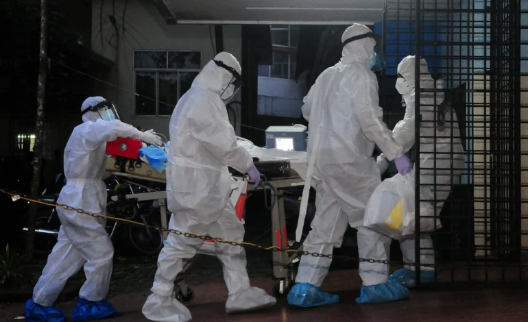 Nipah virus alert in India as hospital staff in protective suits transfer a patient during emergency infection controls