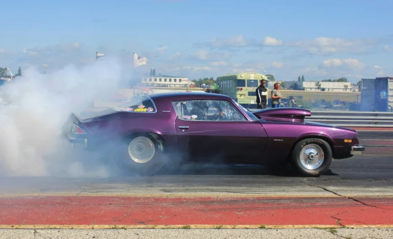 webp a purple 70s camaro burnout at a drag strip