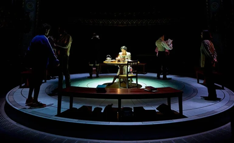 Arcadia Old Vic Theatre review staging with actors around central table in circular set design