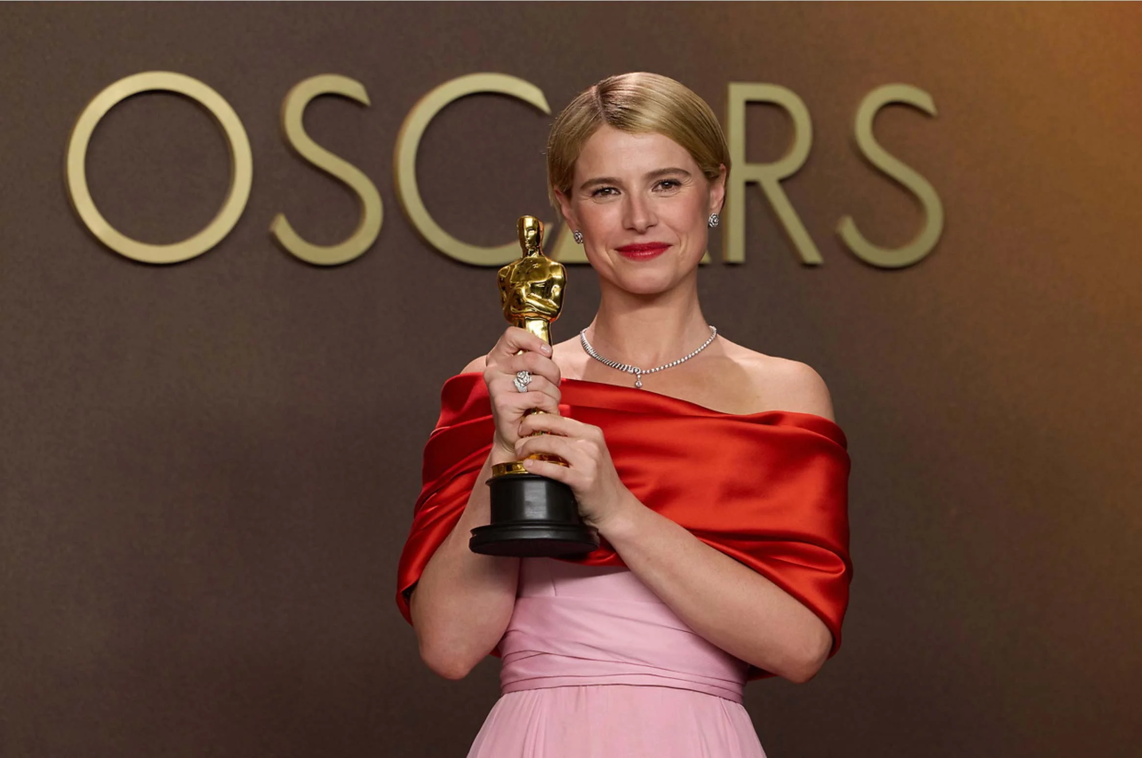 Jessie Buckley holding her Oscar after winning best actress at the Academy Awards
