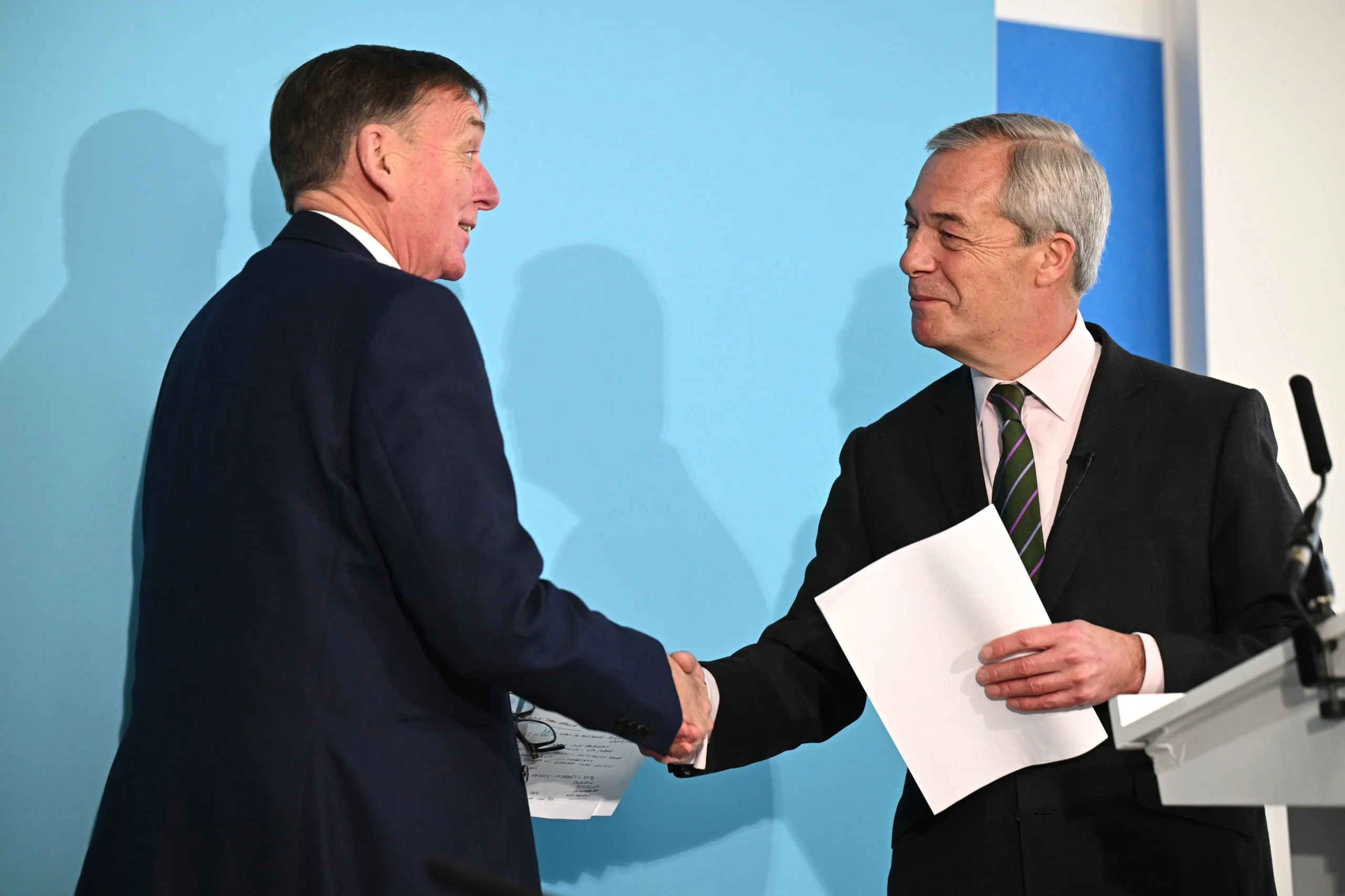 Nigel Farage shakes hands with Sir Robin Wales at a Reform UK press conference in London.