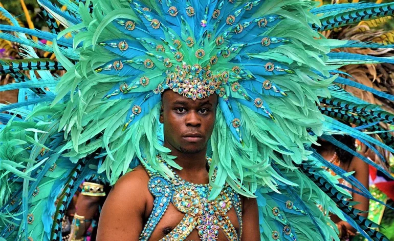 Notting Hill Carnival funding London with performer in feathered costume during parade