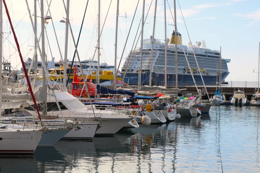 Spirit of Adventure at berth, seen beyond the smaller boats of a busy marina.