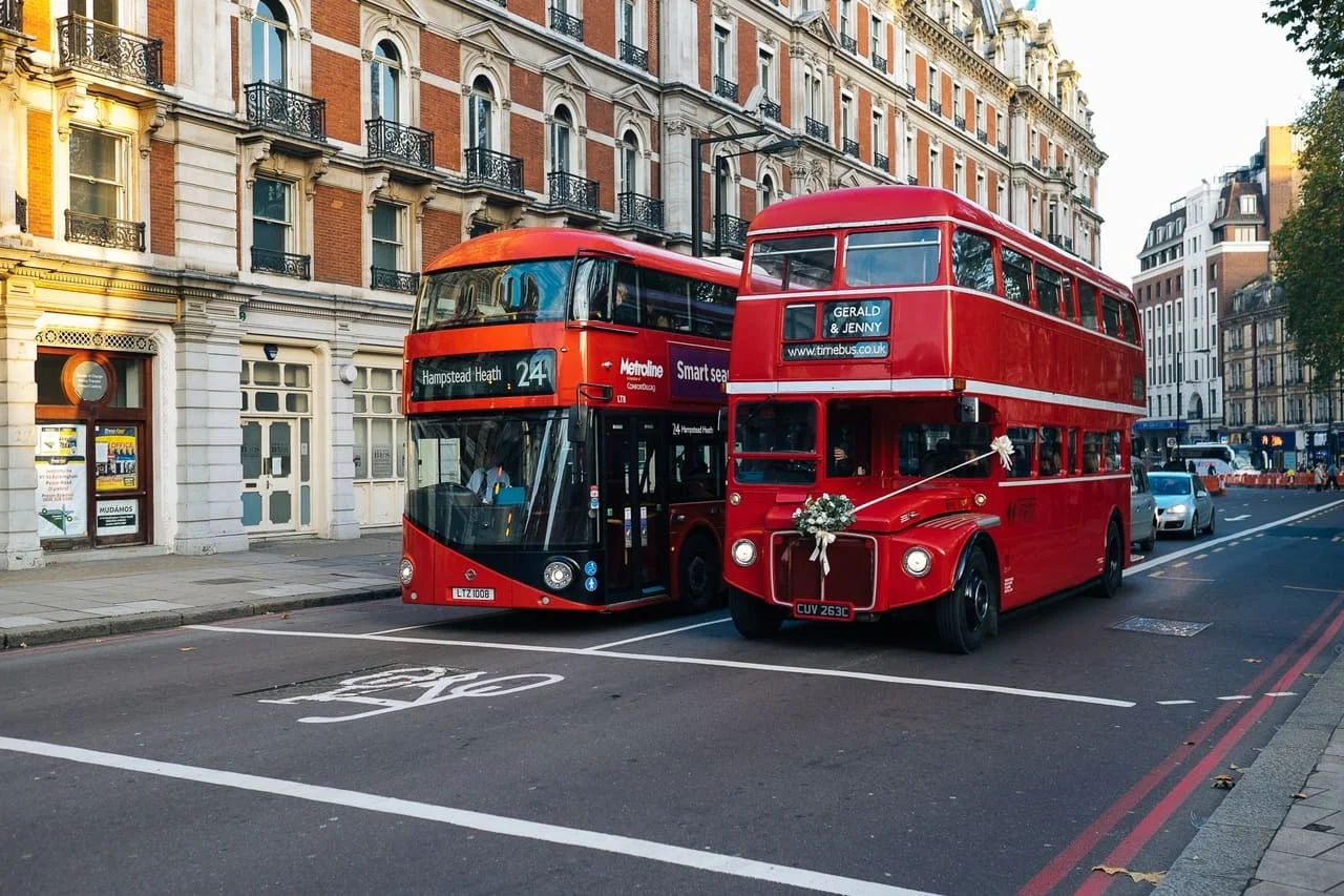 a boris bus next to an original routemaster