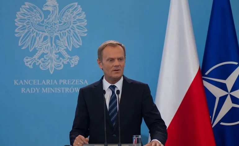 polish pm donald tusk with a lectern and poland and nato flags behind him