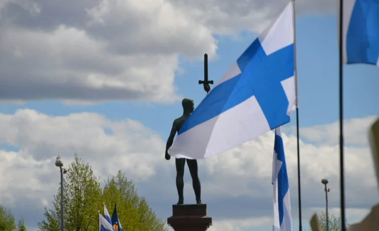 statue and finnish flag