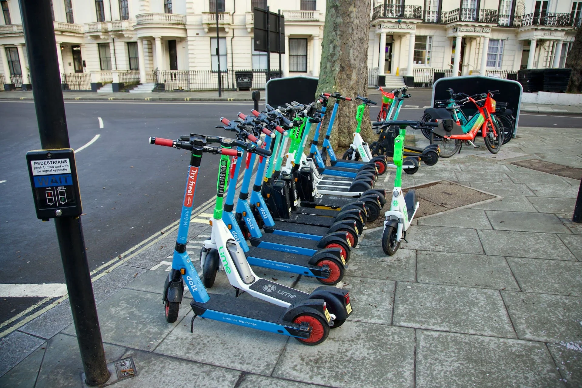 webp image of a bunch of e scooter trial bikes parked by the kerb