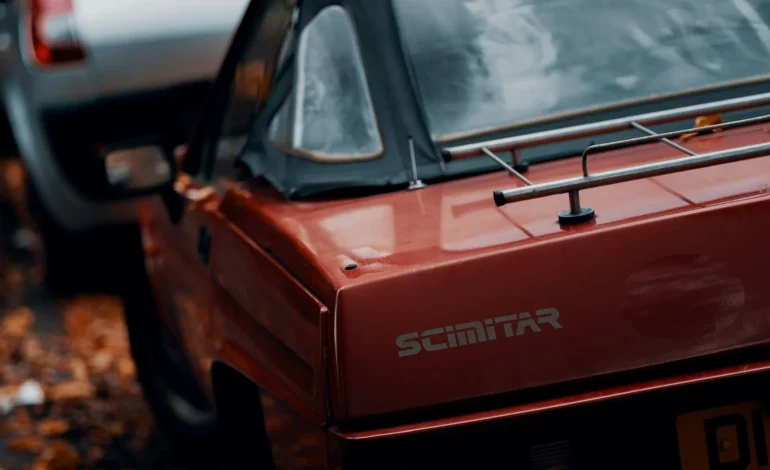 webp red reliant scimitar convertible parked next to silver renault