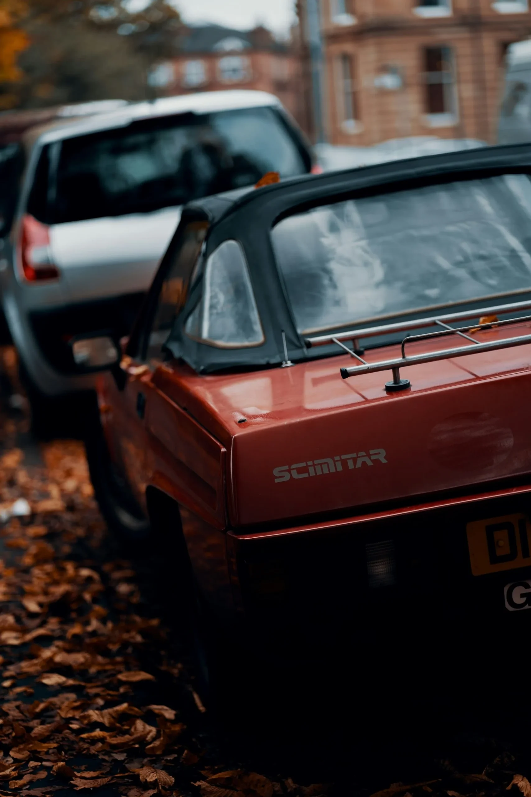 webp red reliant scimitar convertible parked next to silver renault