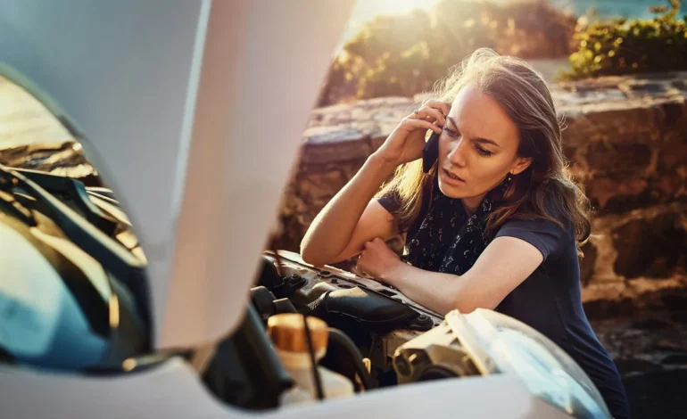 woman next to broken down car