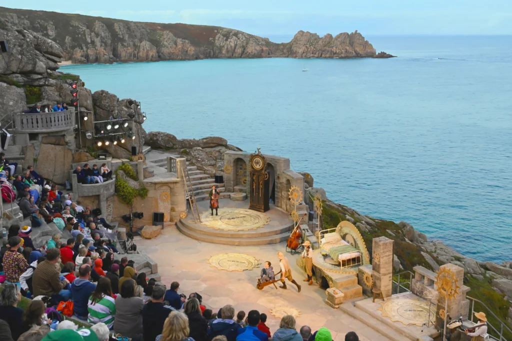 An evening performance at the Minack Theatre unfolds above the Cornish coastline. Image Credit Lynn Batten