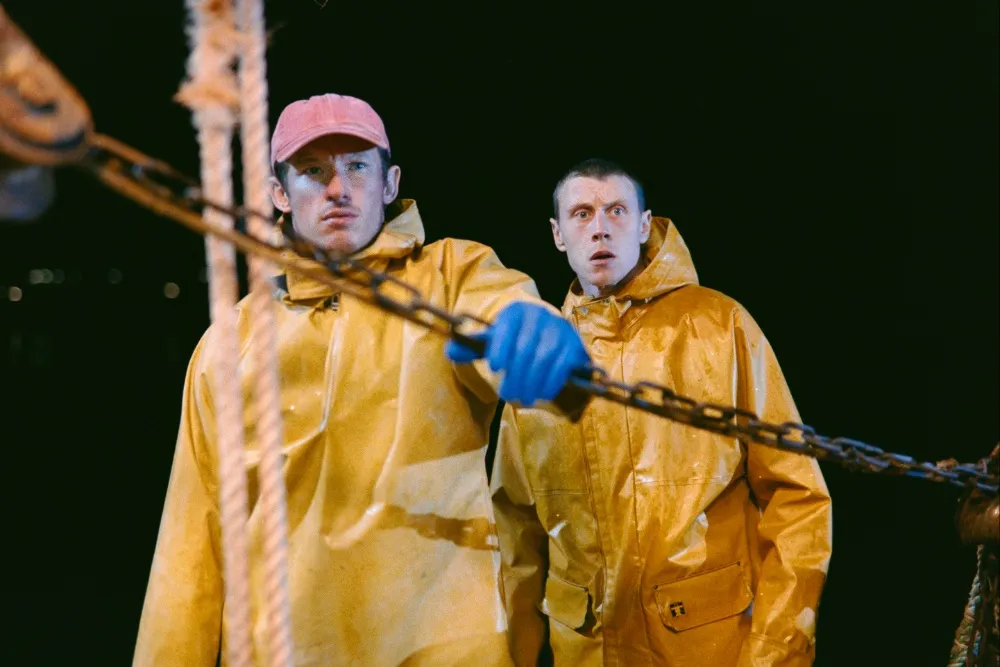 Rose of Nevada film George MacKay Callum Turner fishermen at sea in yellow jackets
