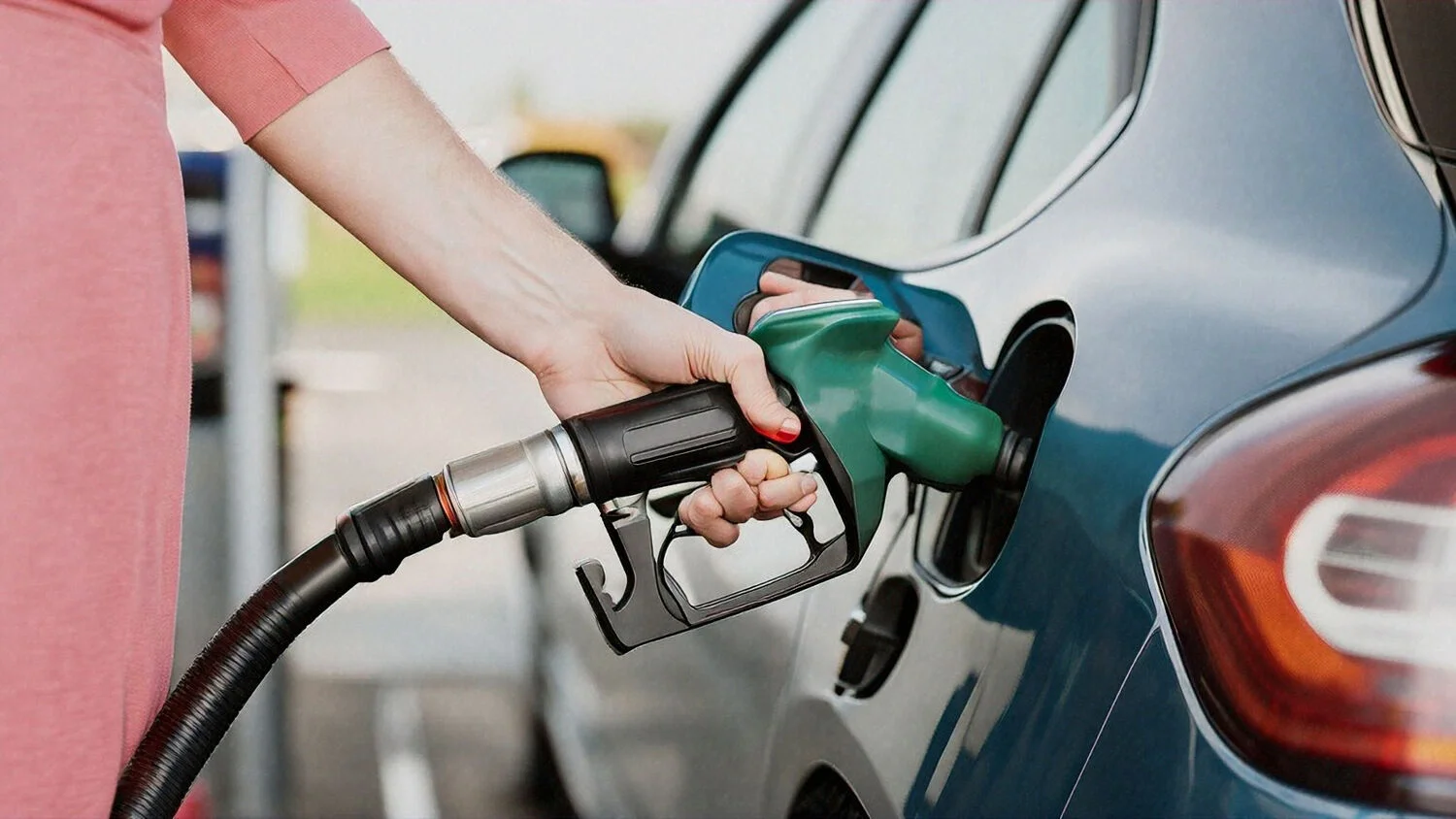 person fuelling up a car