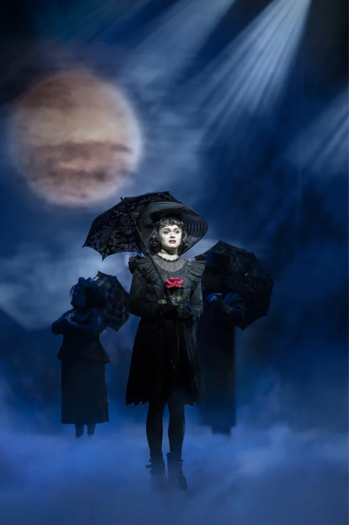Hannah Nordberg's Lydia Deetz, rose in hand, carrying the production's emotional weight even in its quietest, darkest moments.