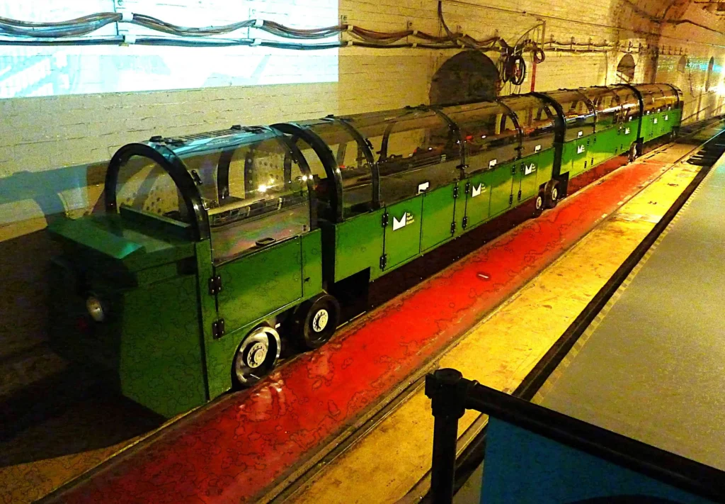 The Mail Rail passenger train in the underground tunnel at the Postal Museum, London. [Image Credit Mike Pickup]
