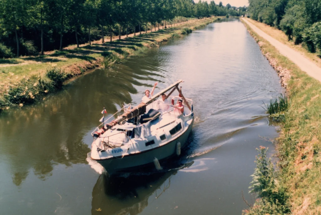 Peter Weaver at the wheel of his boat Fruin navigating a French canal in the 1980s wearing his SAS wings cap