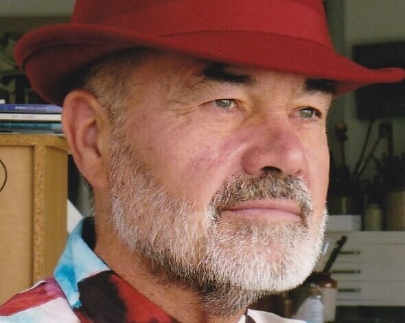 Anthony Lester, art critic and curator, wearing his trademark red hat and colourful shirt