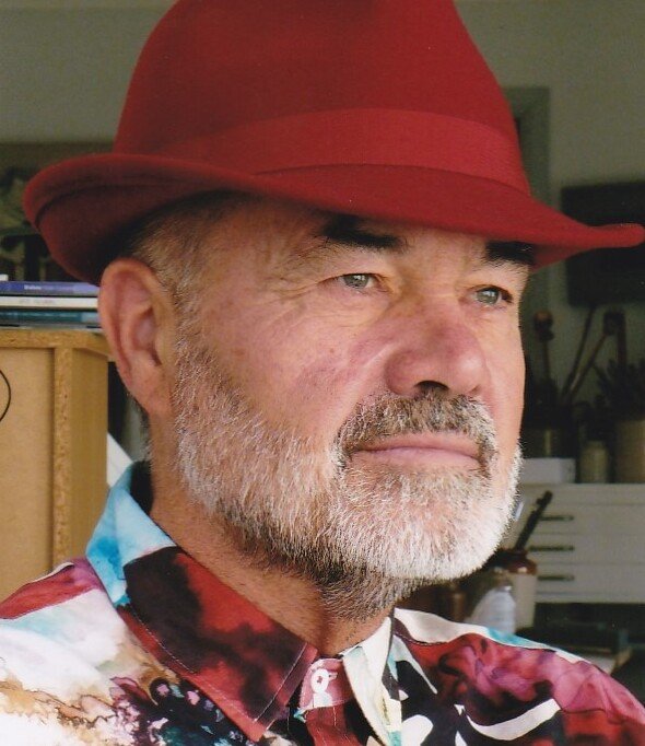 Anthony Lester, art critic and curator, wearing his trademark red hat and colourful shirt