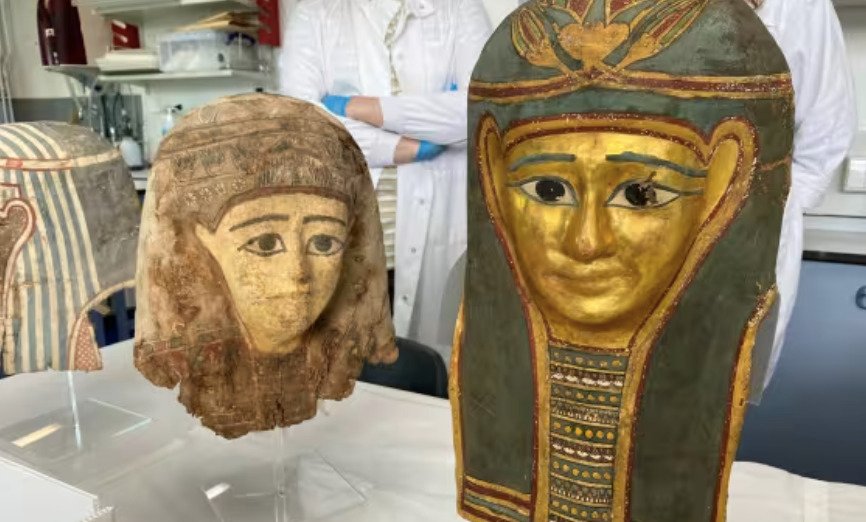 Egypt Exploration Society cartonnage mummy masks displayed during conservation work