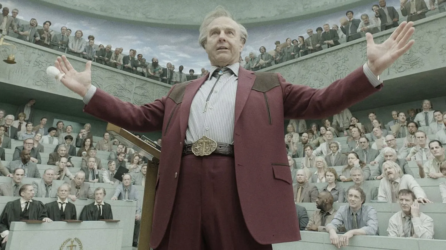Tom Cruise as Digger Rockwell addresses a packed auditorium in Digger