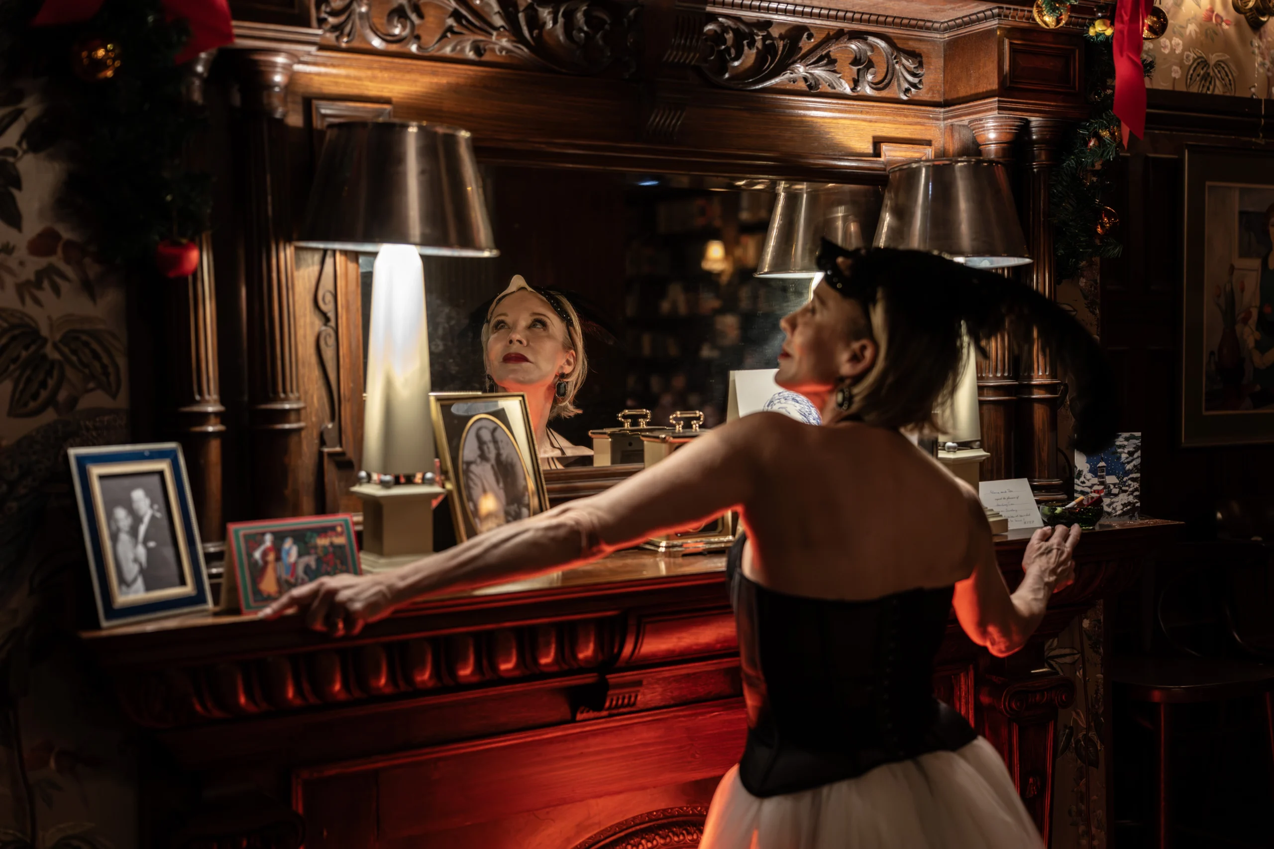 Performer as The Swan reflected in a mirror inside the Tru set at the Menier Chocolate Factory