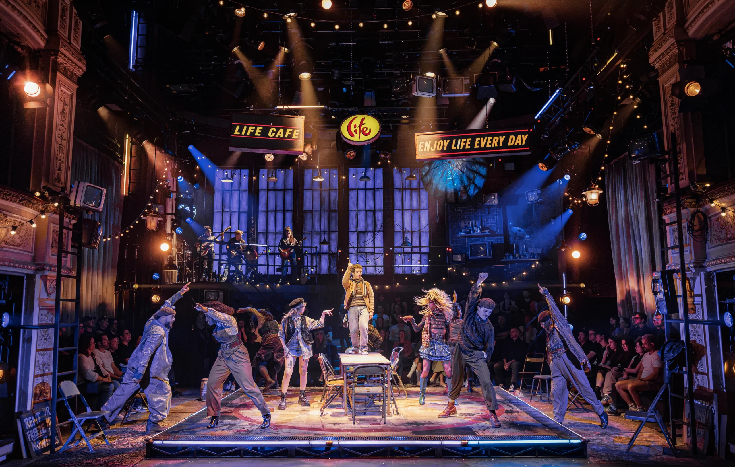 Rent cast performs in the round at the Tom Stoppard Theatre with pyrotechnics overhead