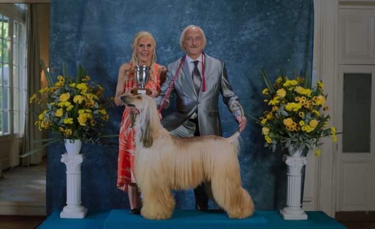 Prince film still, an Afghan Hound show champion flanked by trophy and owners