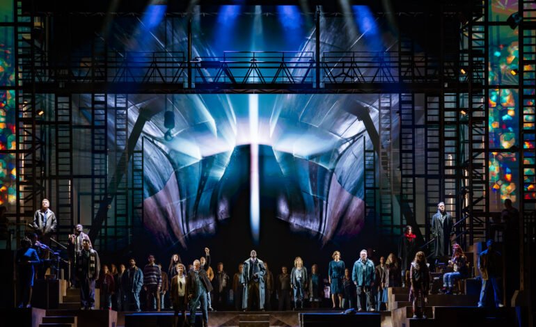 The Last Ship Sting musical company beneath the ship's bow video wall at Drury Lane